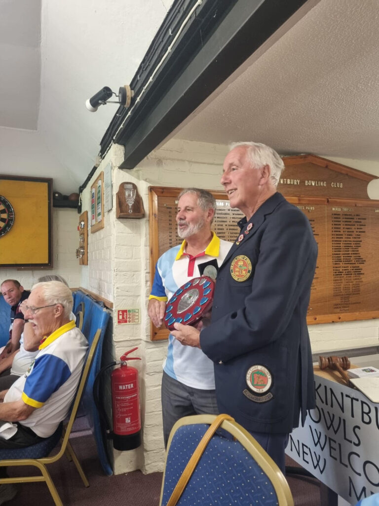 Hungerford Bowls Club member Derek Barton receives the Mick Gainey Shield trophy from Kintbury Bowls Club - 2026