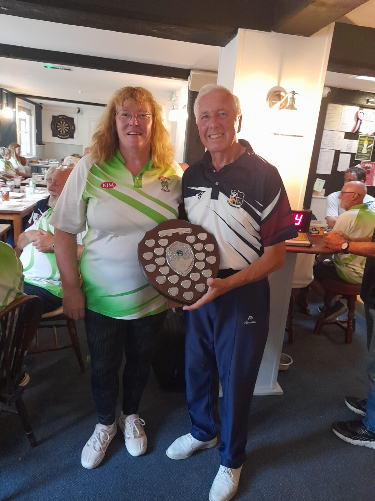Hungerford Bowls Club Captain, Derek Barton, receiving the R&J Broad Trophy from St. Mary Bourne’s Captain - 2026